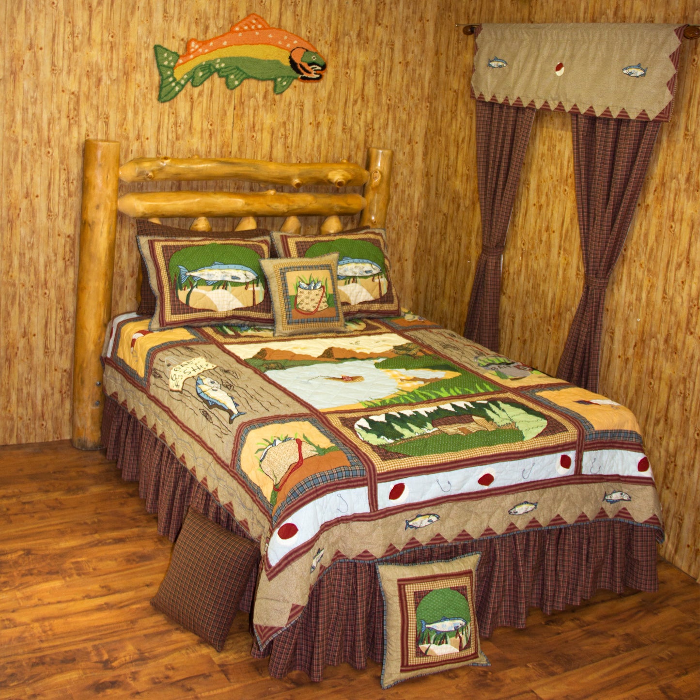 Patch magic's Fishing Break Quilt - This Quilt with brown triangles border depicts a grandeur of a fishing pond surrounded by mountains. The fisherman in the middle of the pond seems to have a hobby and happiness in fishing. He has already caught many fish stuffed in his basket, while he is waiting for a big catch. There is also a farmhouse surrounded by green fields, coniferous trees, and a cotton in the middle.