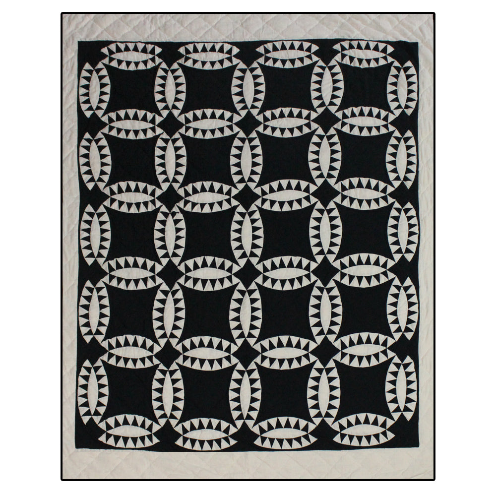 Patch Magic’s Black Wedding Ring Quilt - This black feathered white wedding rings with a black background adorn this quilt with a white border which is 100% Cotton shell and hand layered organic cotton fill. It is hand quilted and hand layered for a unique soft touch and warmth.