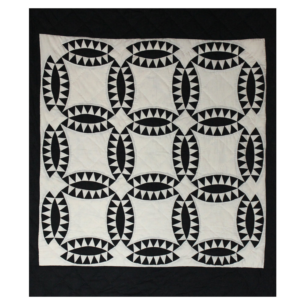 Patch Magic’s Coal Wedding Ring Quilt - This coal black rings with white feathers adorn this quilt having a white background and black border. It is 100% Cotton shell and hand layered organic cotton fill. It is hand quilted and hand layered for a unique soft touch and warmth.