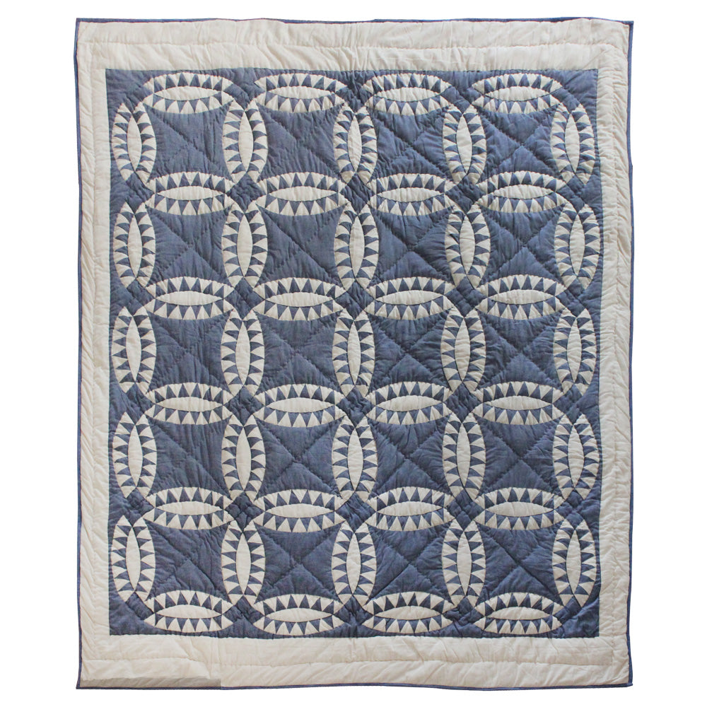 Patch Magic’s Blue Wedding Ring Quilt - This blue feathered white wedding rings with a blue background adorn this quilt with a white border which is 100% Cotton shell and hand layered organic cotton fill. It is hand quilted and hand layered for a unique soft touch and warmth.