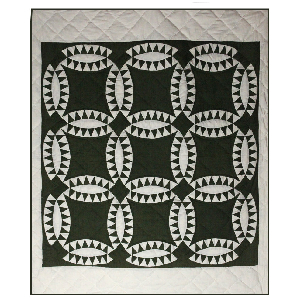Patch Magic’s  Green Wedding Ring Quilt - Green wedding rings intersecting with each other encircled with white hound tooth all around makes this quilt quite attractive and makes you cozy and gives warmth.